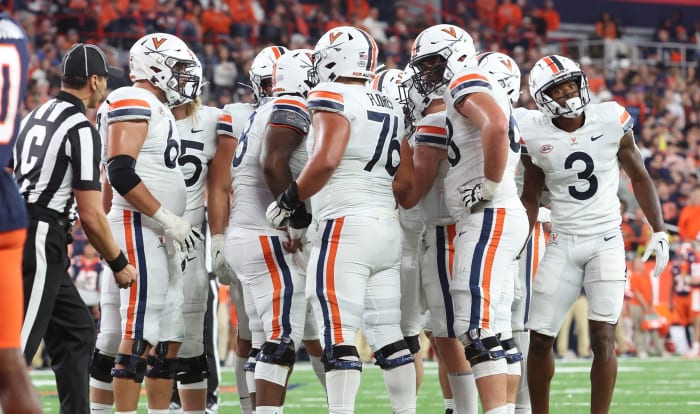 The Virginia Cavaliers offense huddles before a play during the game at Syracuse.